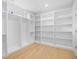 Spacious walk-in closet with custom built-in shelving and hardwood flooring at 2313 Summersweet Ln., Myrtle Beach, SC 29579