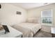 Simple bedroom with a comfortable bed, neutral colors, and a sunny window at 247 Grove Park Grove Park Loop, Murrells Inlet, SC 29576