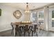 Charming dining room with modern chandelier, rustic table, and ample natural light from the windows at 247 Grove Park Grove Park Loop, Murrells Inlet, SC 29576