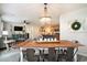 Open concept dining area with stylish chandelier, flowing into the living room and kitchen at 247 Grove Park Grove Park Loop, Murrells Inlet, SC 29576