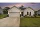 Charming one-story home with a well-maintained lawn, a two-car garage, and tasteful landscaping at 247 Grove Park Grove Park Loop, Murrells Inlet, SC 29576