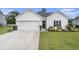 Charming one-story home with a well-maintained lawn, a two-car garage, and tasteful landscaping at 247 Grove Park Grove Park Loop, Murrells Inlet, SC 29576