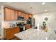 Kitchen featuring granite countertops, stainless steel appliances, and wood cabinets, open to the dining area at 247 Grove Park Grove Park Loop, Murrells Inlet, SC 29576