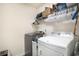 Functional laundry room with washer, dryer, and shelving at 247 Grove Park Grove Park Loop, Murrells Inlet, SC 29576