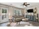 Bright living room features a comfortable sofa, modern decor, and a view to the outdoors at 247 Grove Park Grove Park Loop, Murrells Inlet, SC 29576