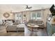 Inviting living room with modern decor and hardwood floors, seamlessly connecting to the dining area at 247 Grove Park Grove Park Loop, Murrells Inlet, SC 29576