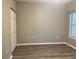 Bedroom featuring wood-look flooring, a large window, and spacious closet at 2498 Coastline Ct. # 301, Murrells Inlet, SC 29576