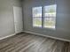Bright bedroom with wood-look floors, a large window and a view of the neighborhood at 2498 Coastline Ct. # 301, Murrells Inlet, SC 29576