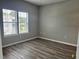 Well-lit bedroom featuring wood-look floors, neutral paint, and large window at 2498 Coastline Ct. # 301, Murrells Inlet, SC 29576