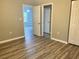 Spacious bedroom with wood-look flooring, closet, and views of the living space at 2498 Coastline Ct. # 301, Murrells Inlet, SC 29576