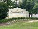 A view of the Sweetwater community sign, surrounded by lush greenery and landscaping at 2498 Coastline Ct. # 301, Murrells Inlet, SC 29576