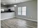 Bright living room area featuring hardwood-style floors, neutral paint, and view of the kitchen at 2498 Coastline Ct. # 301, Murrells Inlet, SC 29576