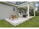 A covered back porch with rocking chairs and a picnic table overlooks a well-maintained lawn at 2554 Dogwood Rd., Longs, SC 29568