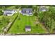 Aerial view of a vast backyard with a shed, playset, and well-manicured lawn, offering endless possibilities at 2554 Dogwood Rd., Longs, SC 29568