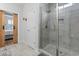 Modern bathroom featuring a tiled shower with glass door and a view into a bedroom through an open sliding door at 2554 Dogwood Rd., Longs, SC 29568
