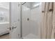 Bathroom with white shower and curtain, light blue walls and a glimpse into an adjacent bedroom at 2554 Dogwood Rd., Longs, SC 29568