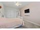 This cozy bedroom features carpet flooring, a ceiling fan, and a wall-mounted TV for ultimate relaxation at 2554 Dogwood Rd., Longs, SC 29568
