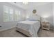 Bright bedroom features a white wooden bed frame, neutral walls, and white plantation shutters on the windows at 2554 Dogwood Rd., Longs, SC 29568