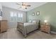 Bedroom with light green accent wall, neutral carpet and walls, and plantation shutters at 2554 Dogwood Rd., Longs, SC 29568