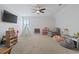 Large bonus room/playroom with neutral walls and carpet, a ceiling fan, TV, and plenty of space for activities at 2554 Dogwood Rd., Longs, SC 29568