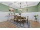 Bright dining room with stylish chandelier, coffered ceiling, wainscoting, and a beautiful area rug at 2554 Dogwood Rd., Longs, SC 29568