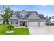 Charming two-story home featuring a three-car garage, well-manicured lawn, and inviting front porch at 2554 Dogwood Rd., Longs, SC 29568