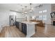 Open-concept kitchen featuring a large island, stainless steel appliances, and seamless flow to the living area at 2554 Dogwood Rd., Longs, SC 29568