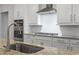 Modern kitchen detail showcasing granite countertops, stainless steel appliances, and white cabinetry at 2554 Dogwood Rd., Longs, SC 29568