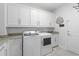 Well-organized laundry room with ample storage, modern appliances, and stylish finishes at 2554 Dogwood Rd., Longs, SC 29568