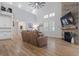 Open living room with high ceilings, a stone fireplace, large windows, and comfortable seating at 2554 Dogwood Rd., Longs, SC 29568
