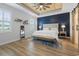 Serene main bedroom with a striking accent wall, wood-look ceiling, and ample natural light at 2554 Dogwood Rd., Longs, SC 29568