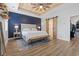 Main bedroom with stylish barn door leading to en-suite bath, accent wall, and wood ceiling at 2554 Dogwood Rd., Longs, SC 29568