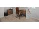 This office features a desk, chair, and storage cabinet on carpet flooring near a staircase at 2554 Dogwood Rd., Longs, SC 29568