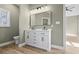 Bathroom featuring double sinks, a large mirror with modern lighting, and stylish vanity against neutral wall at 2715 Wood Creek Ln., Conway, SC 29527