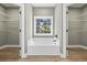 Bright bathroom featuring a soaking tub with a view of the outdoors between two closet doors at 2715 Wood Creek Ln., Conway, SC 29527