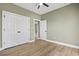 A bedroom with wood-look flooring, and a closet with double doors and dark hardware at 2715 Wood Creek Ln., Conway, SC 29527