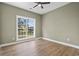 Bedroom featuring wood-look floors, a ceiling fan, recessed lighting, and a large window at 2715 Wood Creek Ln., Conway, SC 29527