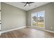 Comfortable bedroom with neutral walls, sleek wood floors, and lots of natural light at 2715 Wood Creek Ln., Conway, SC 29527