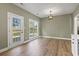 Open dining area with wood-look flooring, backyard access and contemporary lighting at 2715 Wood Creek Ln., Conway, SC 29527