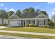 Well-maintained single-story home with a green lawn, an attached garage and meticulous landscaping at 2715 Wood Creek Ln., Conway, SC 29527