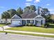 Charming single-story home with a well-manicured lawn, mature trees, and an attached garage at 2715 Wood Creek Ln., Conway, SC 29527