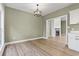 Open living area with wood-look floors and a view into another room with a fireplace at 2715 Wood Creek Ln., Conway, SC 29527
