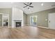 Bright living room featuring a vaulted ceiling and fireplace, along with a window and exterior door at 2715 Wood Creek Ln., Conway, SC 29527