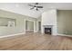 Open-concept living room with a fireplace and wood floors, creating a bright, welcoming space at 2715 Wood Creek Ln., Conway, SC 29527