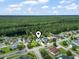 Aerial view of a single-Gathering home surrounded by trees and neighborhood with a pond in the background at 2738 Canvasback Trail, Myrtle Beach, SC 29588