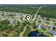 Aerial view of a quiet neighborhood with private pond, and tree-lined streets at 2738 Canvasback Trail, Myrtle Beach, SC 29588