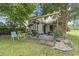 Cozy back patio with a grill, outdoor furniture, and various potted plants and hanging flower baskets under the pergola at 2738 Canvasback Trail, Myrtle Beach, SC 29588