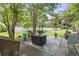 Outdoor patio with chairs, a fire pit, and mature trees with fenced in yard at 2738 Canvasback Trail, Myrtle Beach, SC 29588