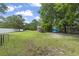 Large grassy backyard with a storage shed, trailer, and kayaks on the side at 2738 Canvasback Trail, Myrtle Beach, SC 29588