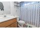 Bathroom with a single sink, wood vanity, and toilet with a shower/tub combo and colorful curtain at 2738 Canvasback Trail, Myrtle Beach, SC 29588